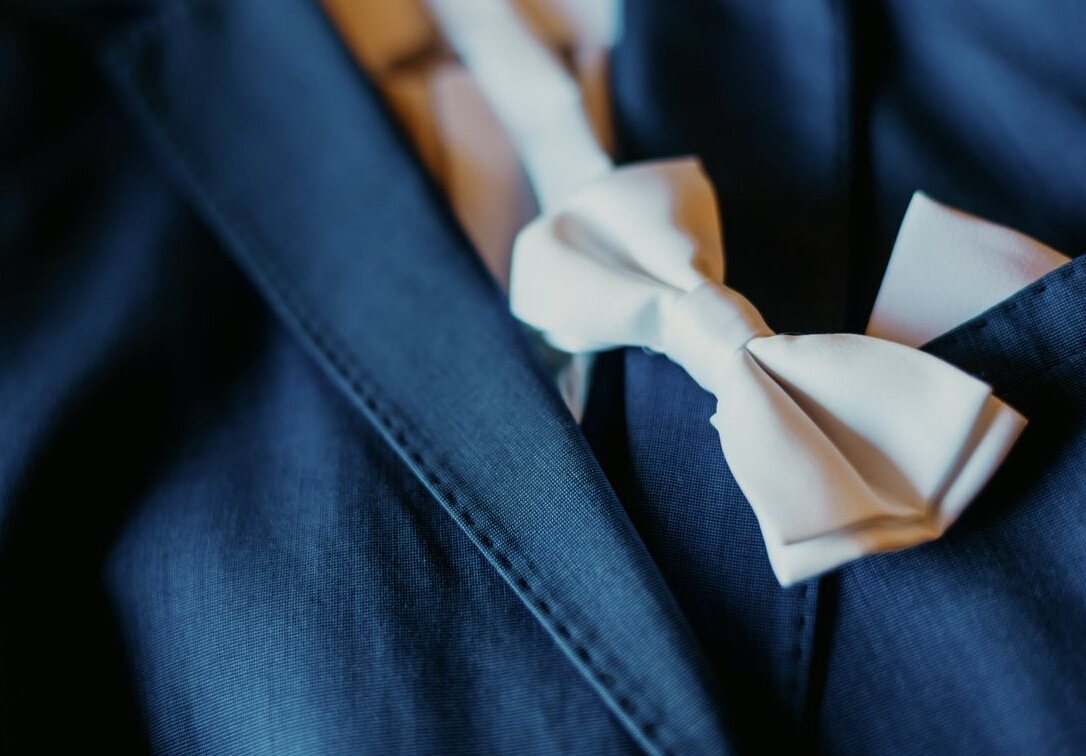 Blue formal suit with a white bow tie and pocket square